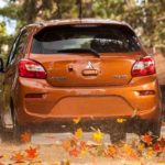 Mitsubishi Mirage driving in the fall