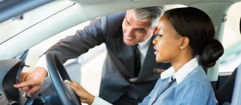 young african woman buying a car